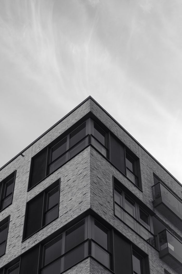 Low-angle view of a modern residential building in Hamburg with a clear sky background.
